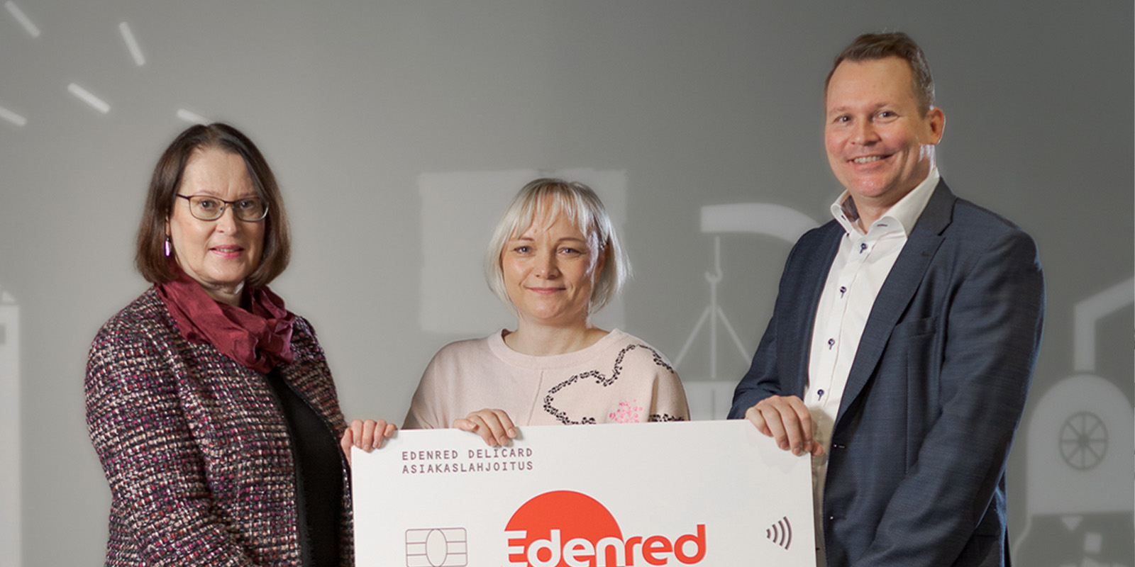 People holding an Edenred donation sign